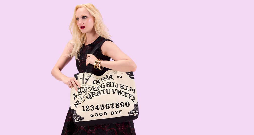 Model showcasing Loungefly Warner Brothers IT Pennywise Crossbuddies Bag